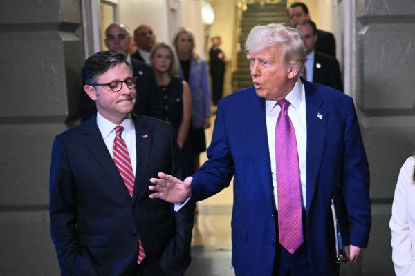 President Donald Trump, joined by Speaker of the House Mike Johnson speaks to reporters as he arrives for a House Republican meeting at the Capitol in Washington, D.C. on May 20, 2025. (Photo by Mandel Ngan/AFP/Getty Images) 