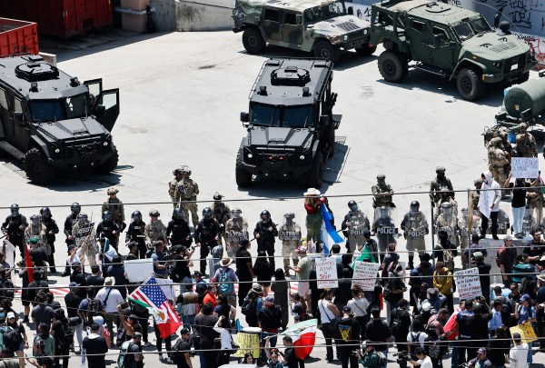 Protesters gather in front of California National Guard soldiers and LAPD officers guarding the Edward R. Roybal Federal building as protests continue in Los Angeles following four days of clashes with police after a series of immigration raids on June 10, 2025. (Photo by Mario Tama/Getty Images)