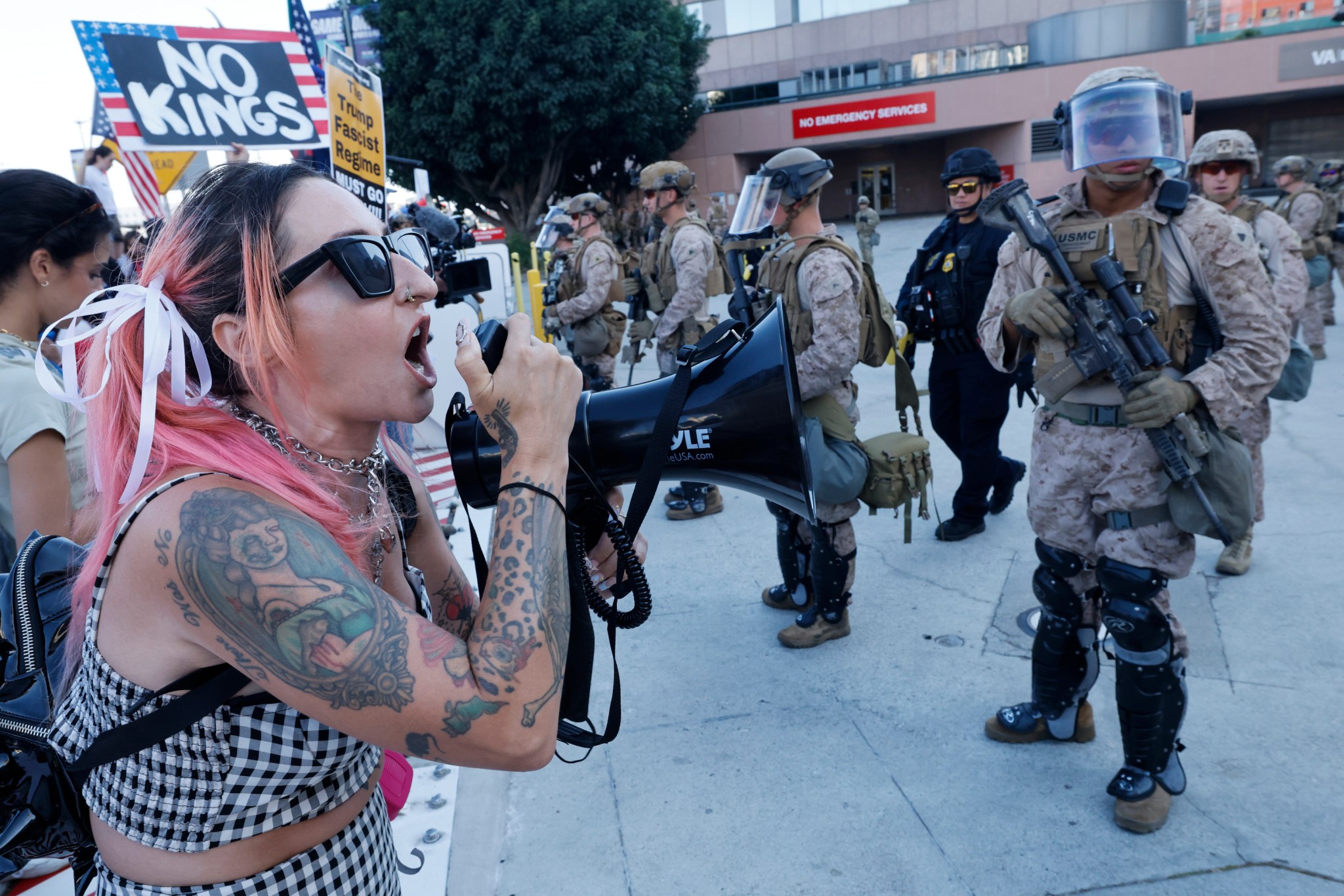 A woman chants in front of marines and DHS police as Angelenos rally against the ongoing ICE raids taking place in the city in front of the Edward R. Roybal Federal Building on Friday, July 4, 2025. (Carlin Stiehl / Los Angeles Times via Getty Images)