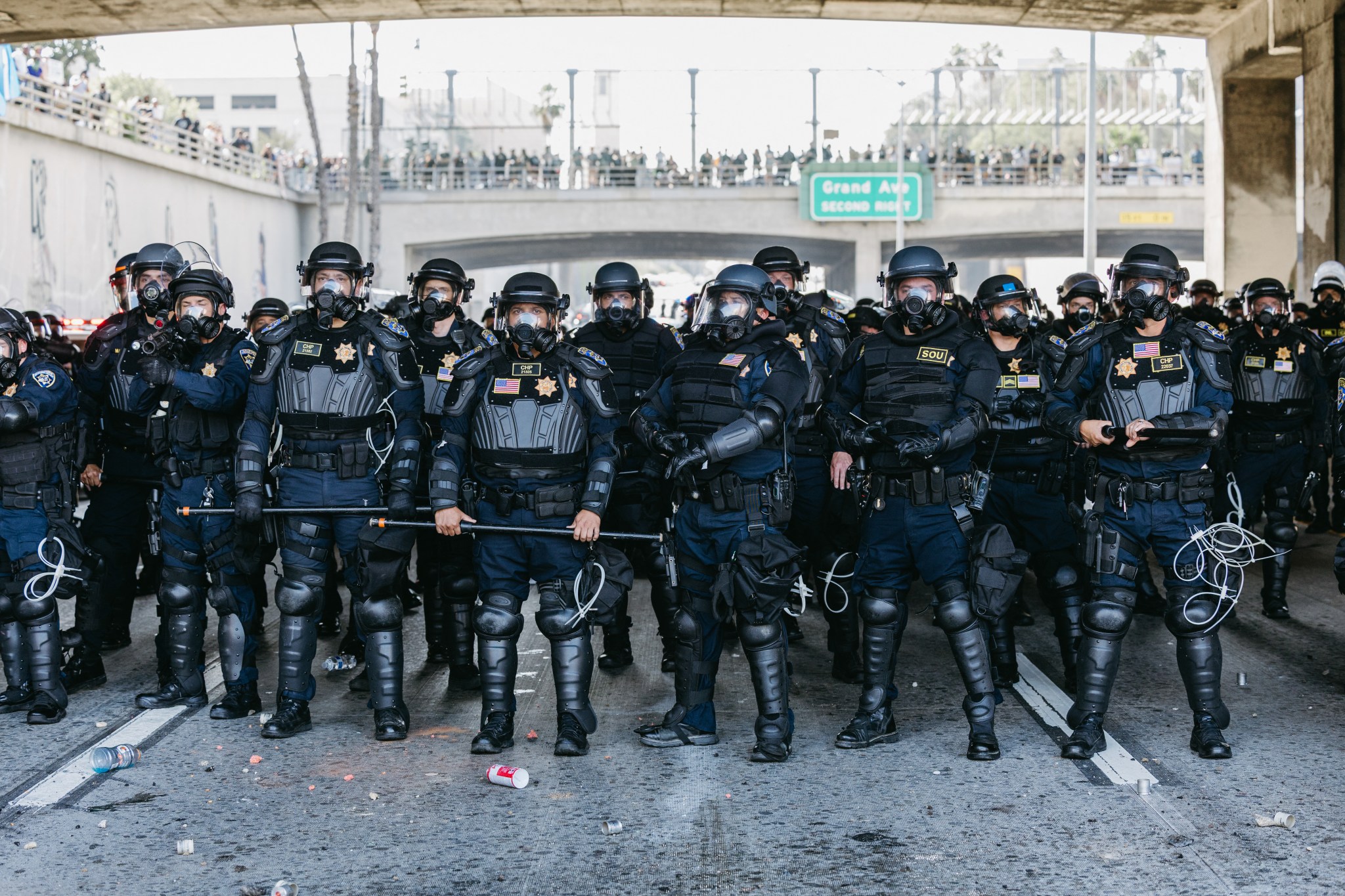 Law enforcement officers stand under an overpass in Los Angeles, California, during a protest on June 8, 2025. (Photo by DAVID PASHAEE/Middle East Images/AFP via Getty Images)