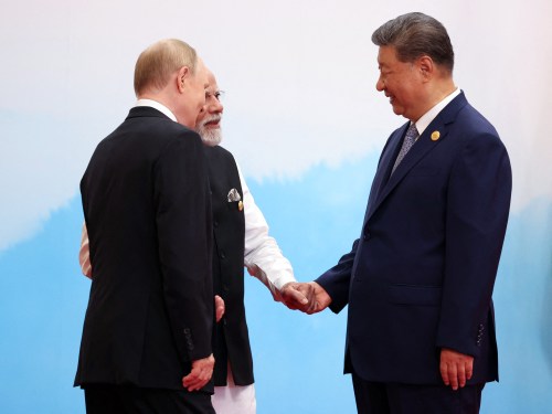 Russian President Vladimir Putin speaks with Indian Prime Minister Narendra Modi and China's President Xi Jinping during the Shanghai Cooperation Organization Summit in Tianjin on September 1, 2025. (Photo by ALEXANDER KAZAKOV/POOL/AFP via Getty Images)