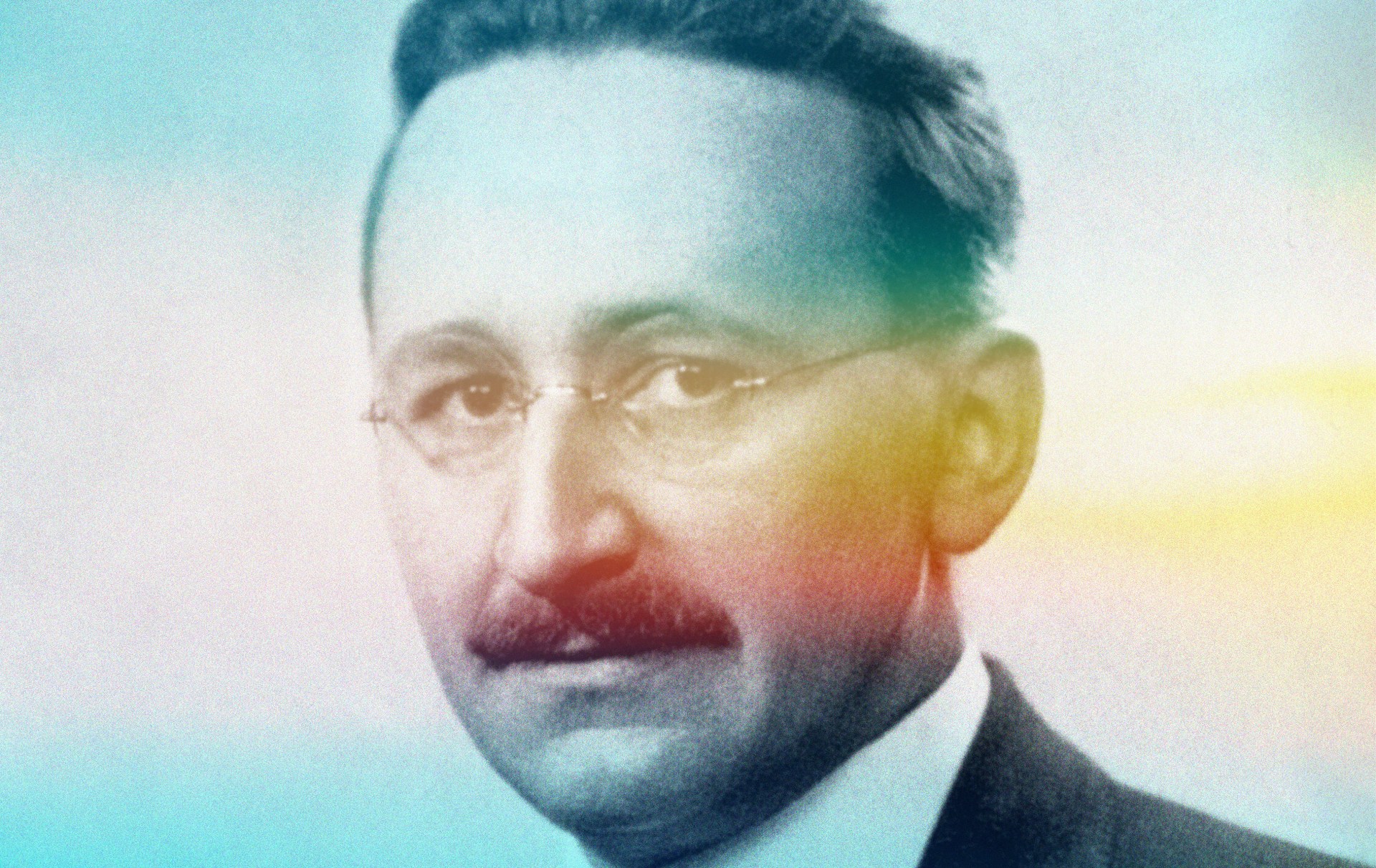 A man with a mustache wearing glasses