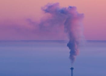A smokestack with smoke coming out of it