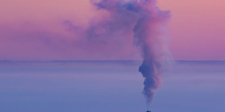 A smokestack with smoke coming out of it