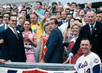 A group of people standing in front of a crowd