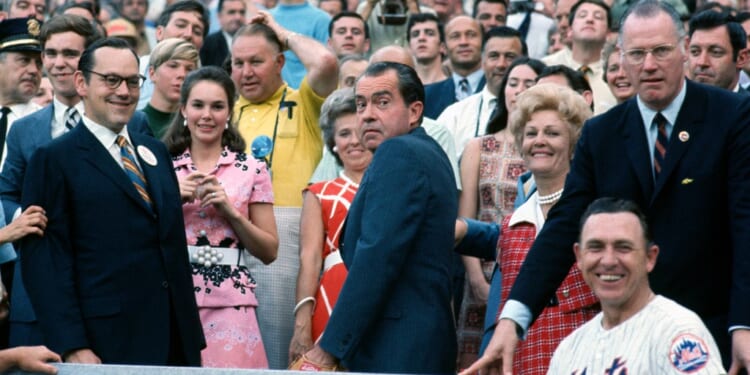 A group of people standing in front of a crowd