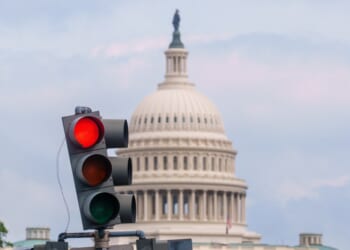 A traffic light with a dome in the background