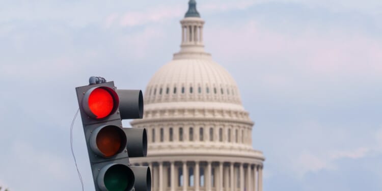 A traffic light with a dome in the background