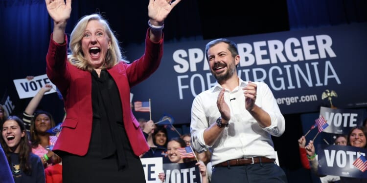 A man and woman with their hands up