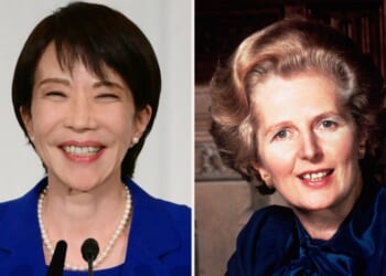 A woman smiling and a woman with a microphone