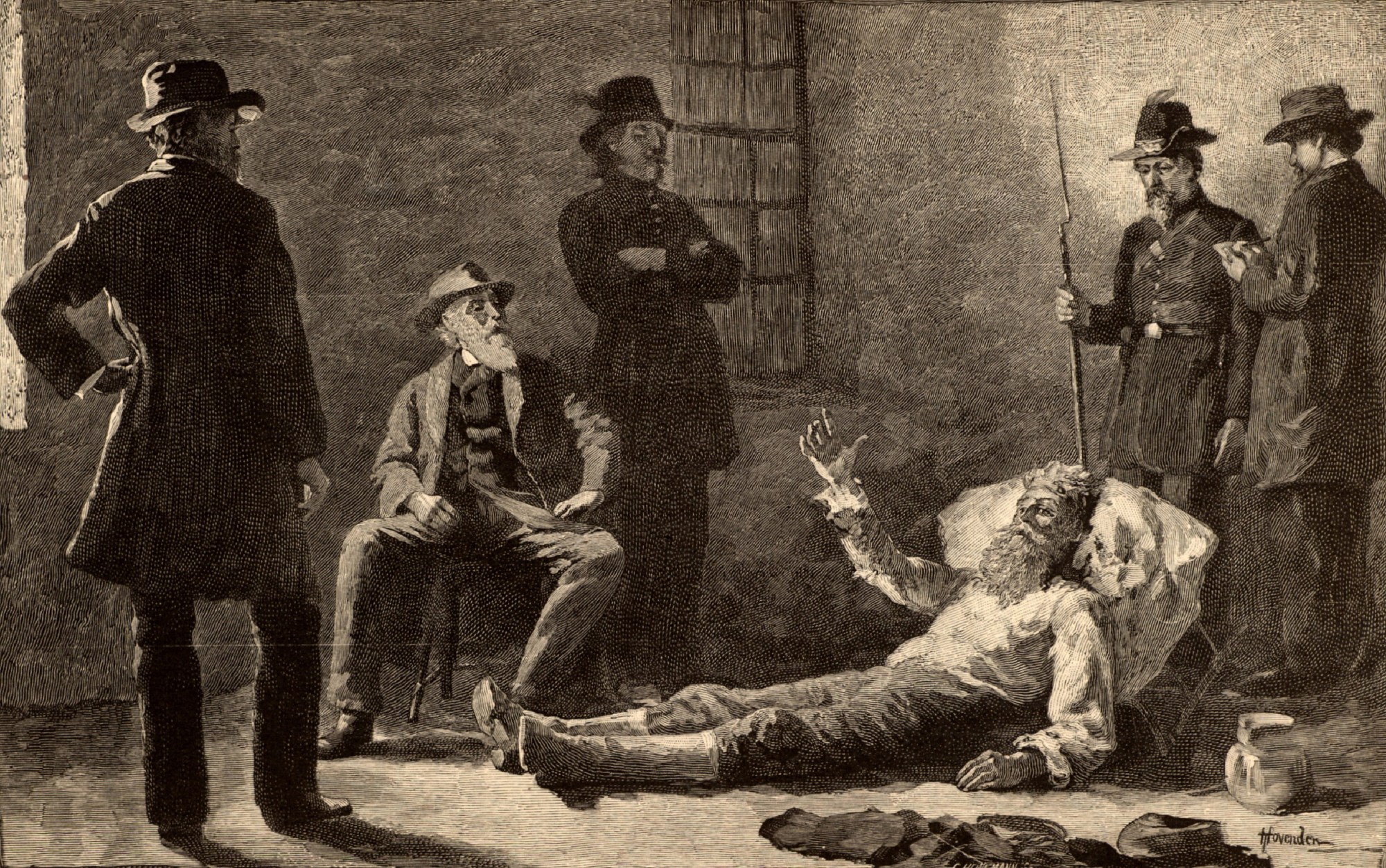 A man lying on the ground with a man in a hat