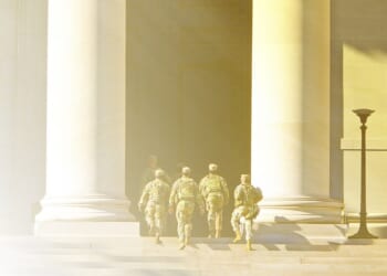 A group of soldiers walking up a staircase