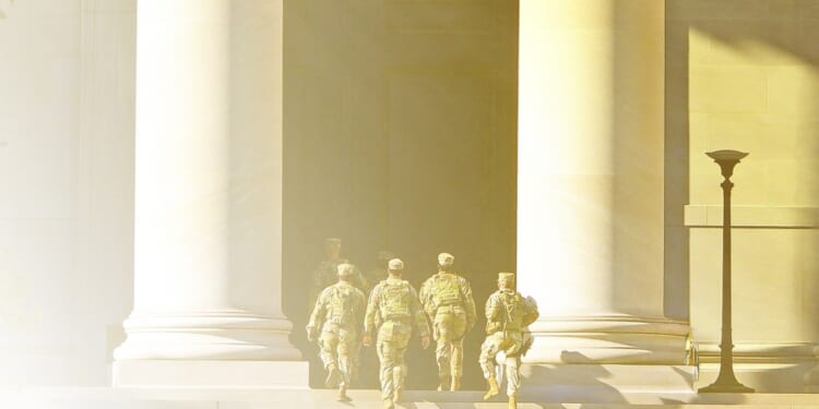 A group of soldiers walking up a staircase