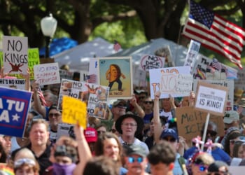 A group of people holding signs