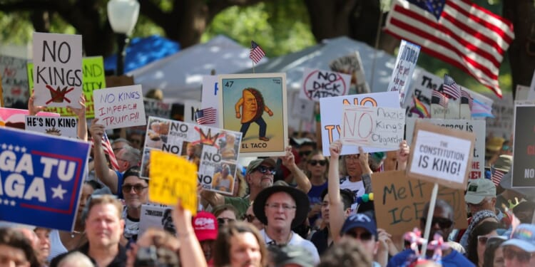 A group of people holding signs