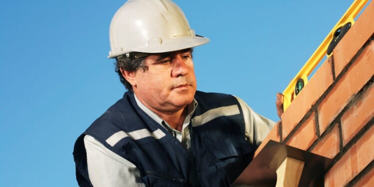 A man wearing a hard hat and vest