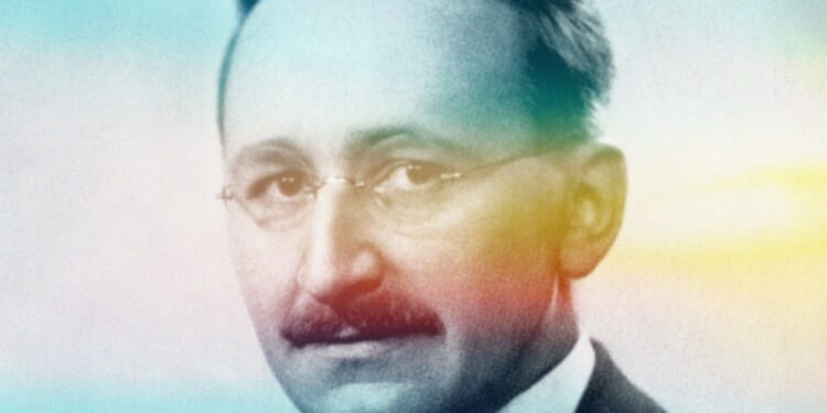 A man with a mustache wearing glasses