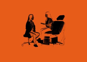 A woman sitting in a chair talking to a woman