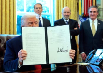 A man holding up a piece of paper