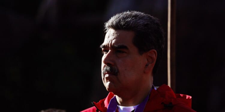 A man with a mustache wearing a red jacket