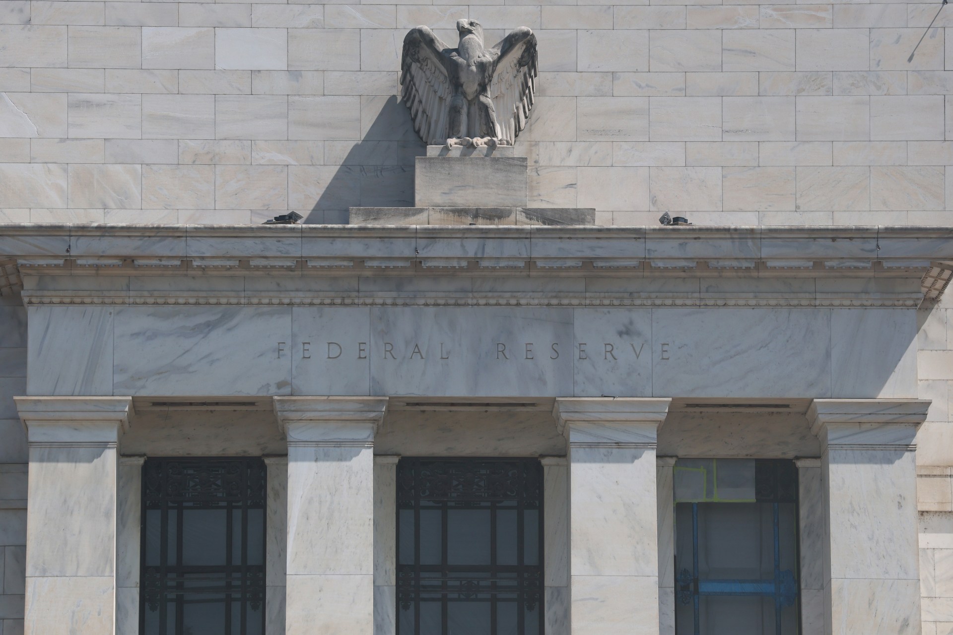 A stone building with a statue on the top