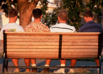 A group of men sitting on a bench