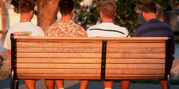 A group of men sitting on a bench