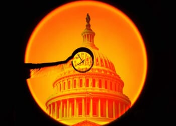 A hand holding a clock