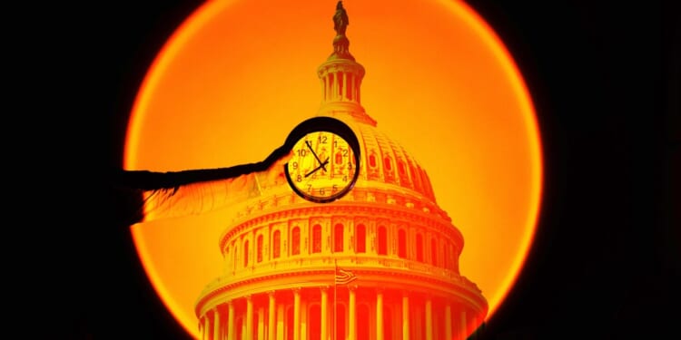 A hand holding a clock