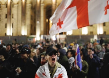 A woman screaming in front of a crowd of people