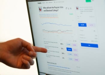 A person pointing at a computer screen