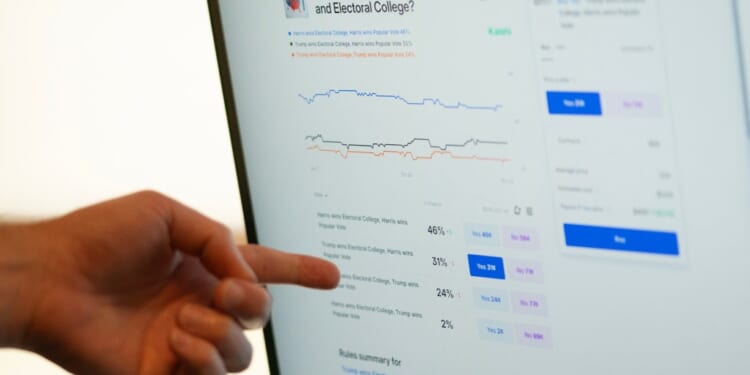 A person pointing at a computer screen