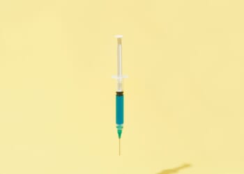 A floating syringe on a yellow background