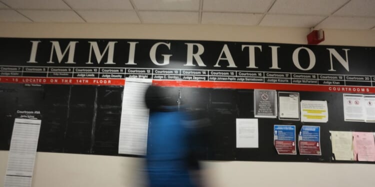 A U.S. Immigration and Customs Enforcement agent inside the Federal Plaza courthouse before making arrests on June 27, 2025 in New York. (Photo by BRYAN R. SMITH/AFP via Getty Images)