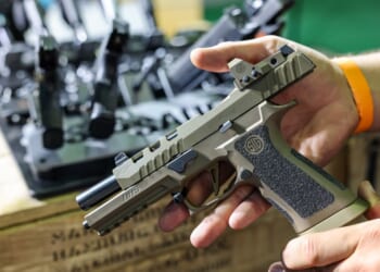 A man shows a SIG Sauer P320 DH3 pistol on 27 September 2024. (Photo by Jan Woitas/picture alliance via Getty Images)