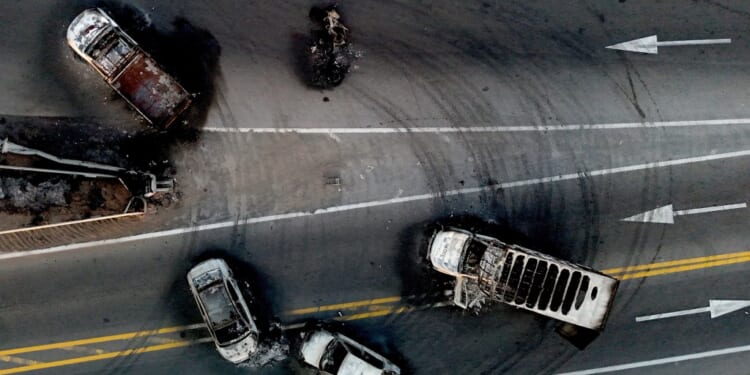Burned cars and trucks, allegedly set on fire by drug cartel members, on a highway near Acatlan de Juarez, Jalisco state, Mexico, on February 22, 2026. (Photo by Ulises Ruiz/AFP via Getty Images)