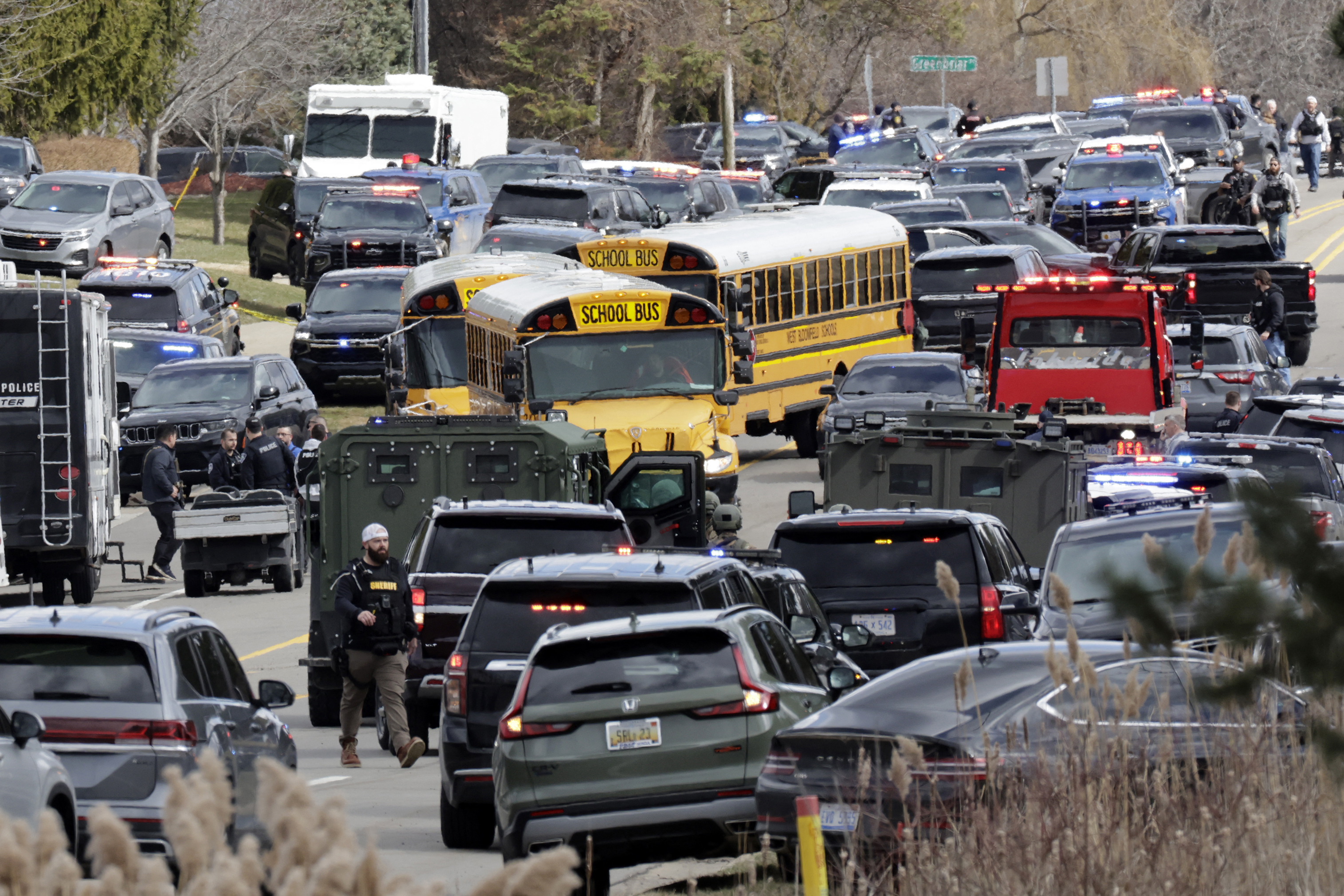 TOPSHOT – Law enforcement responds at the scene of a shooting on Walnut Lake Rd, outside of Temple Israel synagogue, in West Bloomfield, Michigan, a suburb of Detroit, on March 12, 2026. An unidentified shooter was killed on March 12 after exchanging gunfire with security in an attack on a synagogue in the outskirts of Detroit, Michigan, police said. Police said the gunman was dead following the attack on the Temple Israel synagogue in West Bloomfield. (Photo by JEFF KOWALSKY / AFP via Getty Images)