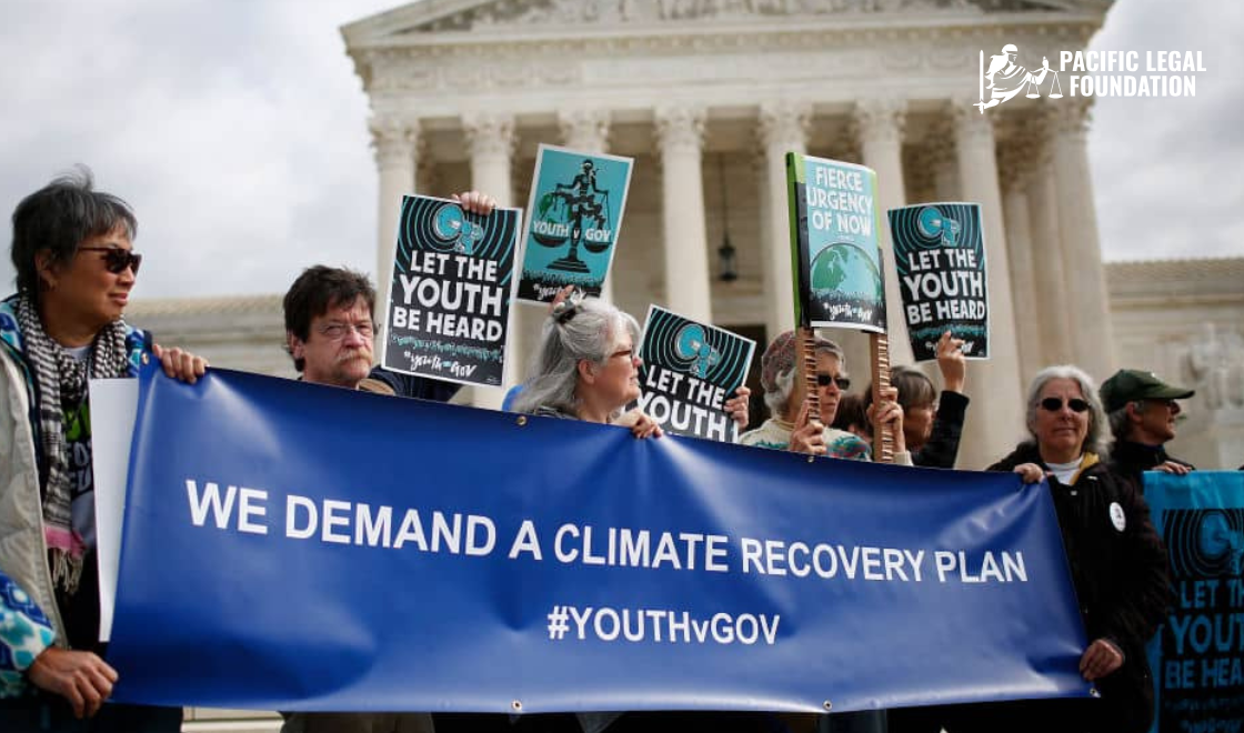 # Alt Text Climate activists and youth demonstrators hold signs and a banner reading 